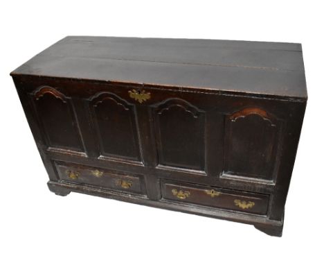 An 18th century oak coffer, the hinged cover with panelled front and two base drawers, on bracket feet, width 133cm, depth 53