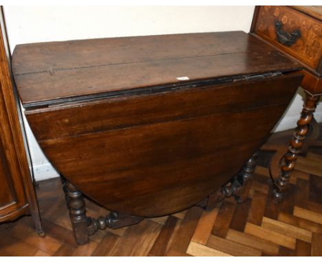 An 18th century oak drop-leaf gateleg dining table on bobbin turned supports, width 103cm, height 70cm.&nbsp;