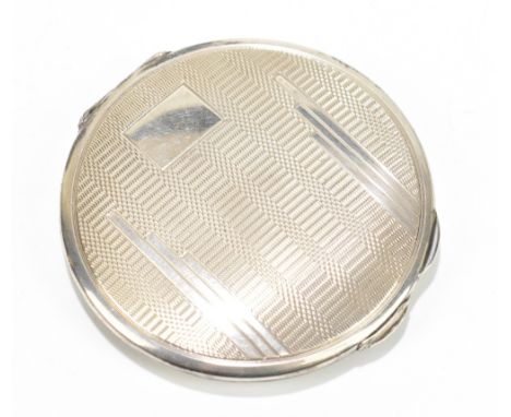 A hallmarked silver compact of circular form with engine turned decoration in the Art Deco style, diameter 6cm.Additional Inf