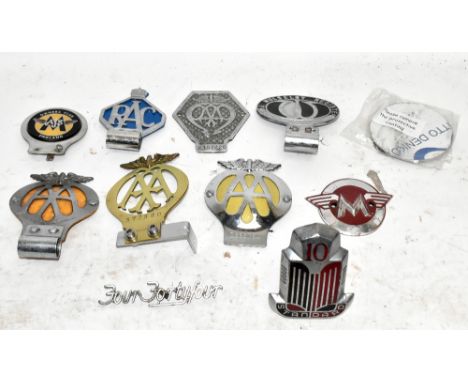 Nine vintage car badges, including three AA, a Wolseley Register and a Standard.&nbsp;