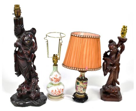 A Japanese carved root wood figural table lamp representing a hunter beside a dragon, height including fitment 54cm, another 