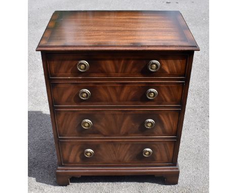 A reproduction mahogany chest of four drawers, on bracket feet.