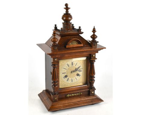 A German walnut eight day mantel clock, with Roman numeral chapter ring and movement striking on a gong, height 46cm.