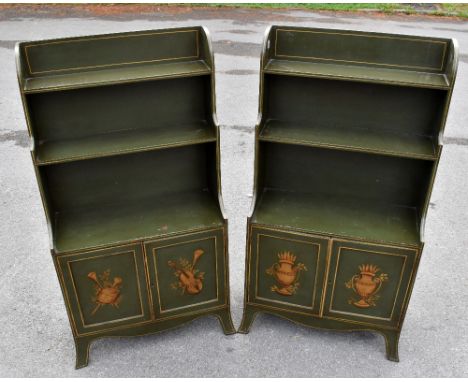 A pair of reproduction green and gilt painted waterfall bookcases, with two fixed shelves above a pair of doors, and shaped b