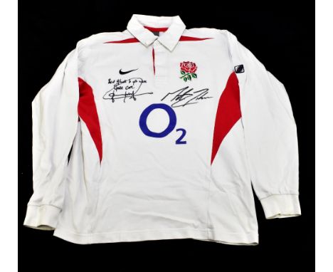 ENGLAND; a 2003 rugby shirt, signed to the front by Wilkinson and Johnson, size L.Additional InformationCreasing and light ge