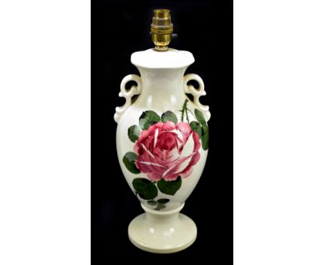 IN THE MANNER OF WEMYSS; a cream glazed rose painted twin handled table lamp, unmarked, height including fitment 39cm.