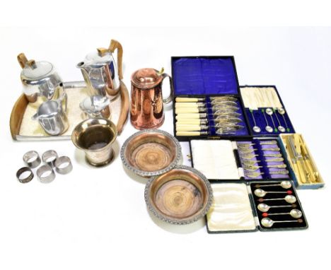 An assortment of metalware including a pair of Sheffield plate bottle coasters, a British made copper jug with planished deco