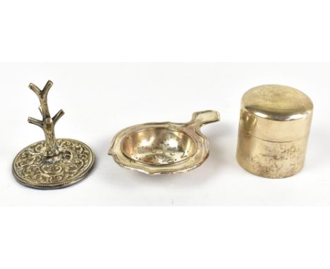 SAMPSON MORDAN &amp; CO; an Edward VII hallmarked silver inkwell, London 1901, a hallmarked silver tea strainer and ring stan