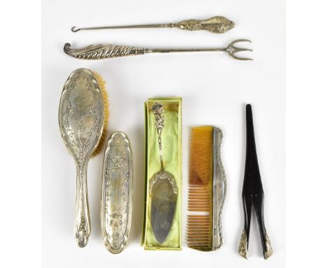 A small collection of hallmarked silver items&nbsp; including a part dressing table set, a clock stand, a button hook, and 80