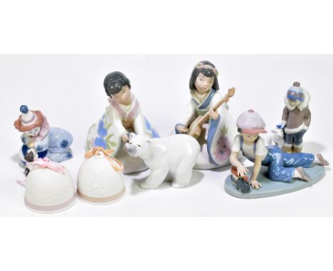 LLADRO; 'All Aboard', a figure of a boy with a train, length 19cm, with a Lladro figure of a clown, a figure of a boy with a 