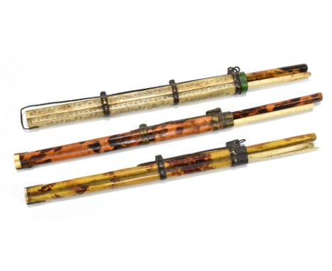 A group of three Japanese travelling sets comprising a thin bladed knife and a pair of bone sticks, two with simulated tortoi