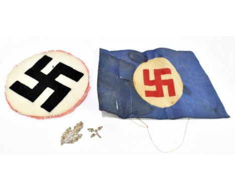 A circular German Third Reich patch (cut from something), a perishing German Third Reich silk banner and an oak leaf and acor