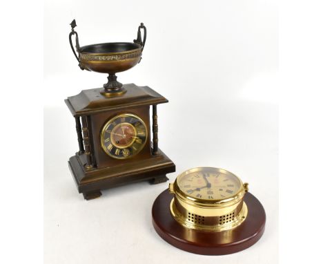 A late 19th century brass eight day mantel clock, with eight day movement striking on a gong, and twin handled urn mount, hei