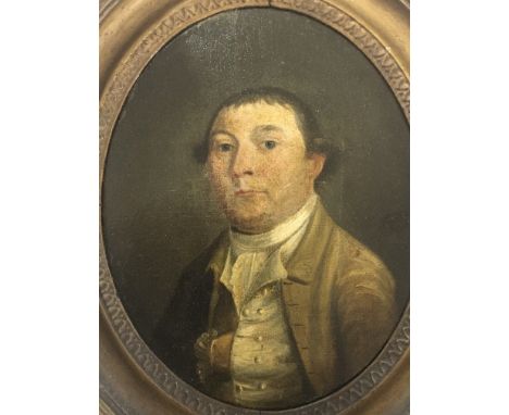 An 18th century oil painting on panel portrait of a young Gentleman in an oval frame The reverse with an inscription Mathew W