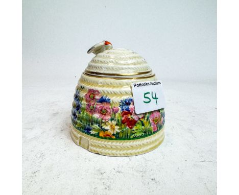 Clarice Cliff Newport Pottery beehive honey pot &amp; cover, floral design, slight slither chip to base, h.10cm 