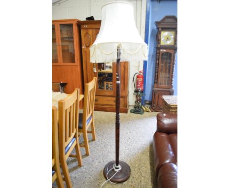 TURNED WOODEN STANDARD LAMP WITH PALE FABRIC SHADE