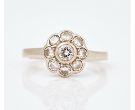 A diamond nine stone cluster ringCollet set with the principal circular cut diamond at the centre, in a surround of eight sma