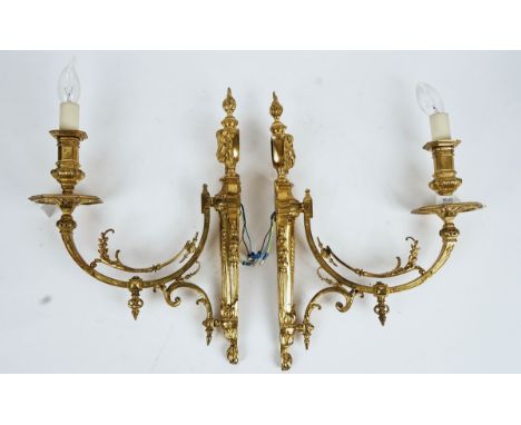 A pair of Louis XVI style ormolu wall lights20th CenturyEach with a foliate-cast tapering backplate surmounted by a classical