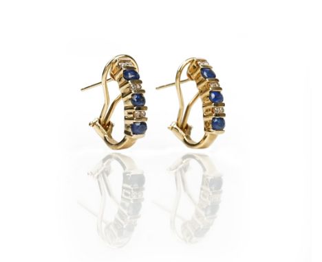 A pair of gold, sapphire and diamond earclipseach mounted with three oval cut sapphires and with three pairs of circular cut 