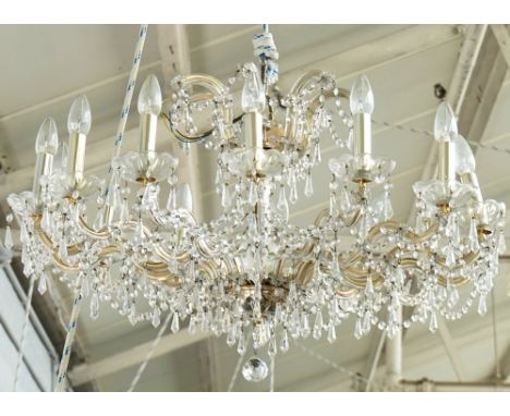 A pair of gilt-metal and glass fourteen light chandeliers20th CenturyThe scroll branches hung with faceted cut-glass drops44c