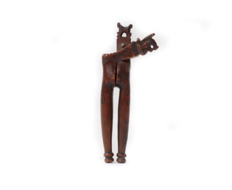 A Queen Anne / George I yew-wood lever-action nutcrackerCirca 1710Topped by a squirrel eating a nut, and scratch-carved with 