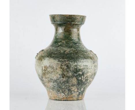 A Chinese green glazed pottery vase, HuHan dynastyset with taotie mask and ring handles, 30cm highSome chips, glaze loss and 