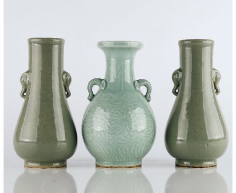 A group of three Chinese carved celadon vases20th centurycomprising; a pair of vases carved with a lotus pattern and set with