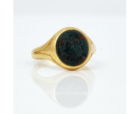 An 18ct gold and bloodstone oval signet ringThe oval bloodstone crest seal engraved, London 1925, ring size Q and a half, gro