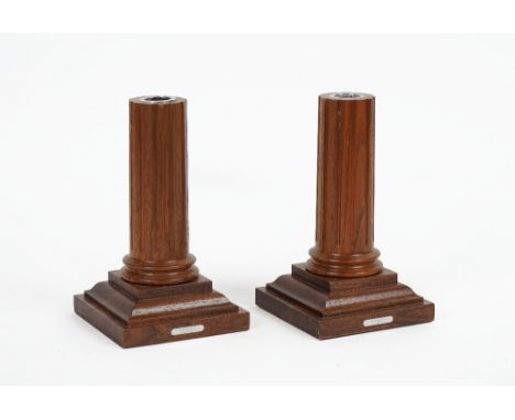 LINLEY LONDON; A pair of mahogany candlesticksModernOf truncated columnar form, on stepped square bases with inset metal plaq