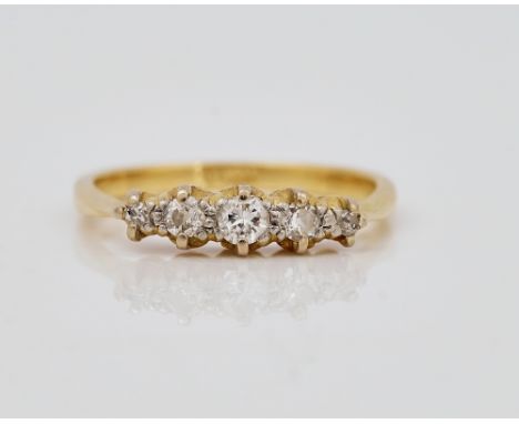 A gold and diamond set five stone ringMounted with a row of circular cut diamonds graduating in size to the centre stone, det