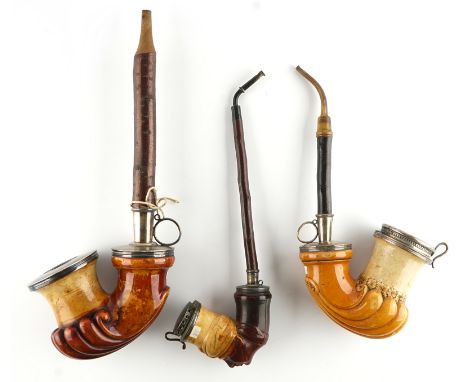 THREE MEERSCHAUM PIPES (3)19th CenturyA large meerschaum pipe with Austrian silver mounts, the scalloped bowl with a hinged c