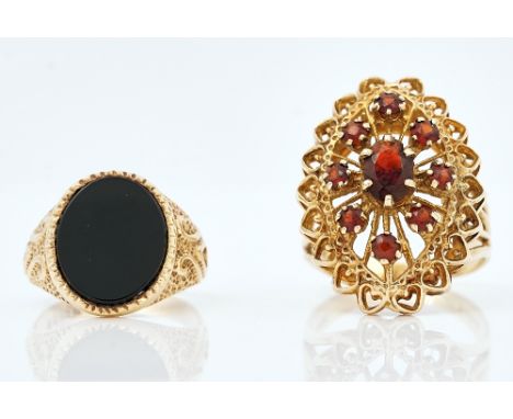 Two 9ct gold rings (2)A garnet set marquise shaped cluster ring, having pierced decoration, ring size R and a half, gross wei