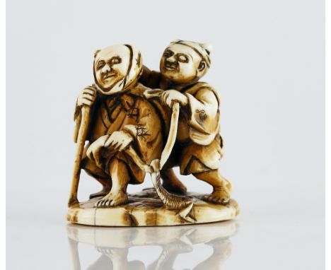 A Japanese ivory netsuke of two blind menMeiji periodone leading with a stick, the other following behind holding a rope, sig