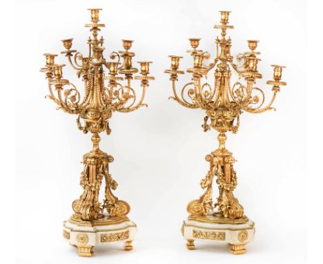 A pair of French gilt-metal and white marble ten-light candelabra20th CenturyIn the Louis XVI style, the scroll branches abov