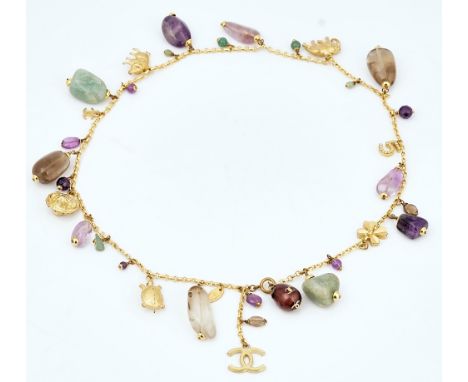 A Chanel gilt metal and polished hardstone necklaceThe gilt metal oval link neckchain fitted with gilt metal charms and penda