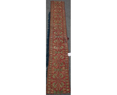 An embroidered tapestry panelthe madder background with indigo embroidered birds; an indigo tassel, 35cm wide; 226cm highIndi