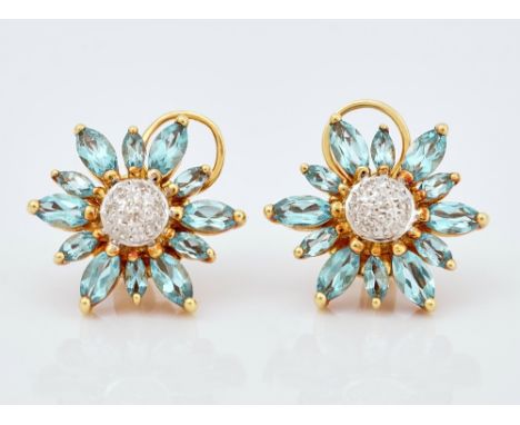 A pair of gold, blue topaz and diamond set earstudsEach of flowerhead shaped design, mounted with circular cut diamonds to th