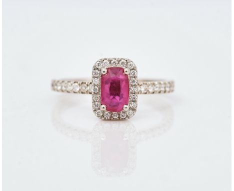 A ruby and diamond ringClaw set with the rectangular cushion shaped mixed cut ruby, in a surround of circular cut diamonds, b
