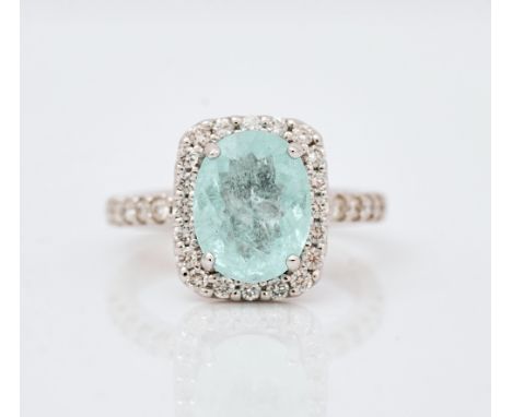 An 18ct white gold, paraiba tourmaline and diamond cluster ringClaw set with oval cut natural paraiba tourmaline, in a curved