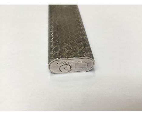 Cartier white metal lighter with engine turned decoration, signed Cartier, Paris and numbered 152408. Height 70mm