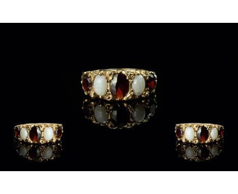 18ct Gold Attractive Opal &amp; Garnet Set Ring - Gallery Setting. Ring Size (N) Weight 3.3 grams. Chip to one of the Opals, 