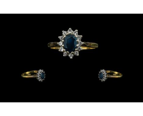 18ct Sapphire and Diamond Cluster Ring with central sapphire surrounded by 12 round cut diamonds. Fully hallmarked. Ring size