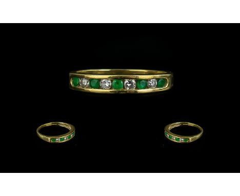 18ct Gold Emerald and Diamond Half Eternity Ring set with alternating round cut emeralds and diamonds. Fully hallmarked ring 