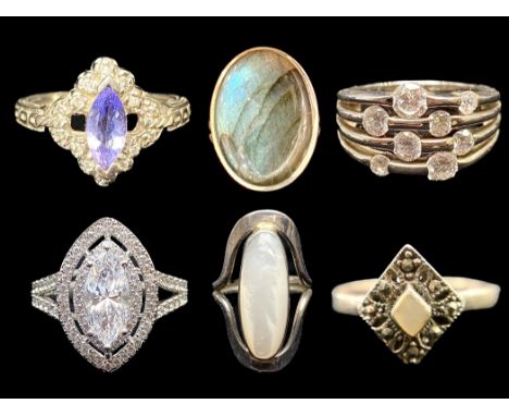 Six Ladies Silver Rings, comprising a crystal set oval ring, a diamond shaped Marcasite ring with a central white stone, a la