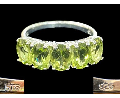 Peridot Half Eternity Ring, five oval cut, bright, sparkling peridots, totalling 4cts, closely set in a row, across the finge