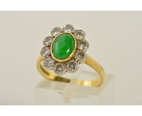 AN 18CT GOLD JADE AND DIAMOND CLUSTER RING, designed as a central oval jade cabochon within a collet setting to the brilliant