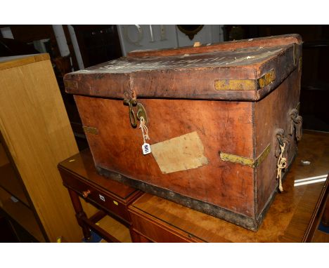 A TAN LEATHER MILITARY TRUNK, with various labels and painted lettering, width 71cm x depth 44cm x height 46cm (one handle da