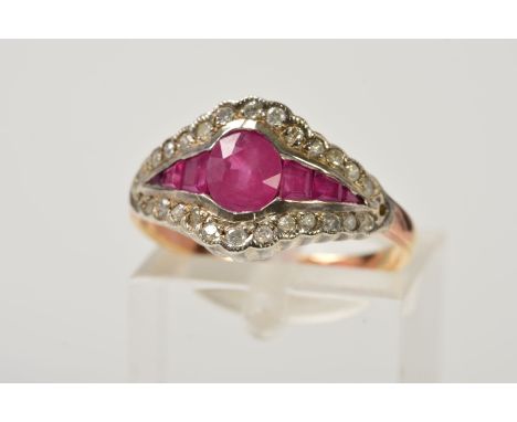 A RUBY AND DIAMOND DRESS RING, designed with a central oval ruby flanked by graduated rectangular cut rubies, edged by single