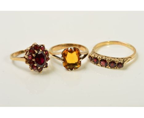 THREE GEM RINGS, the first a graduated five stone garnet ring with scrolling gallery, with 9ct hallmark, ring size S1/2, the 