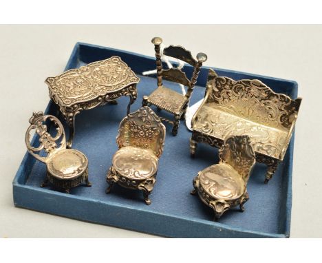 SIX PIECES OF MINIATURE SILVER AND WHITE METAL FURNITURE, comprising a table, four chairs and a sofa, some pieces bearing imp